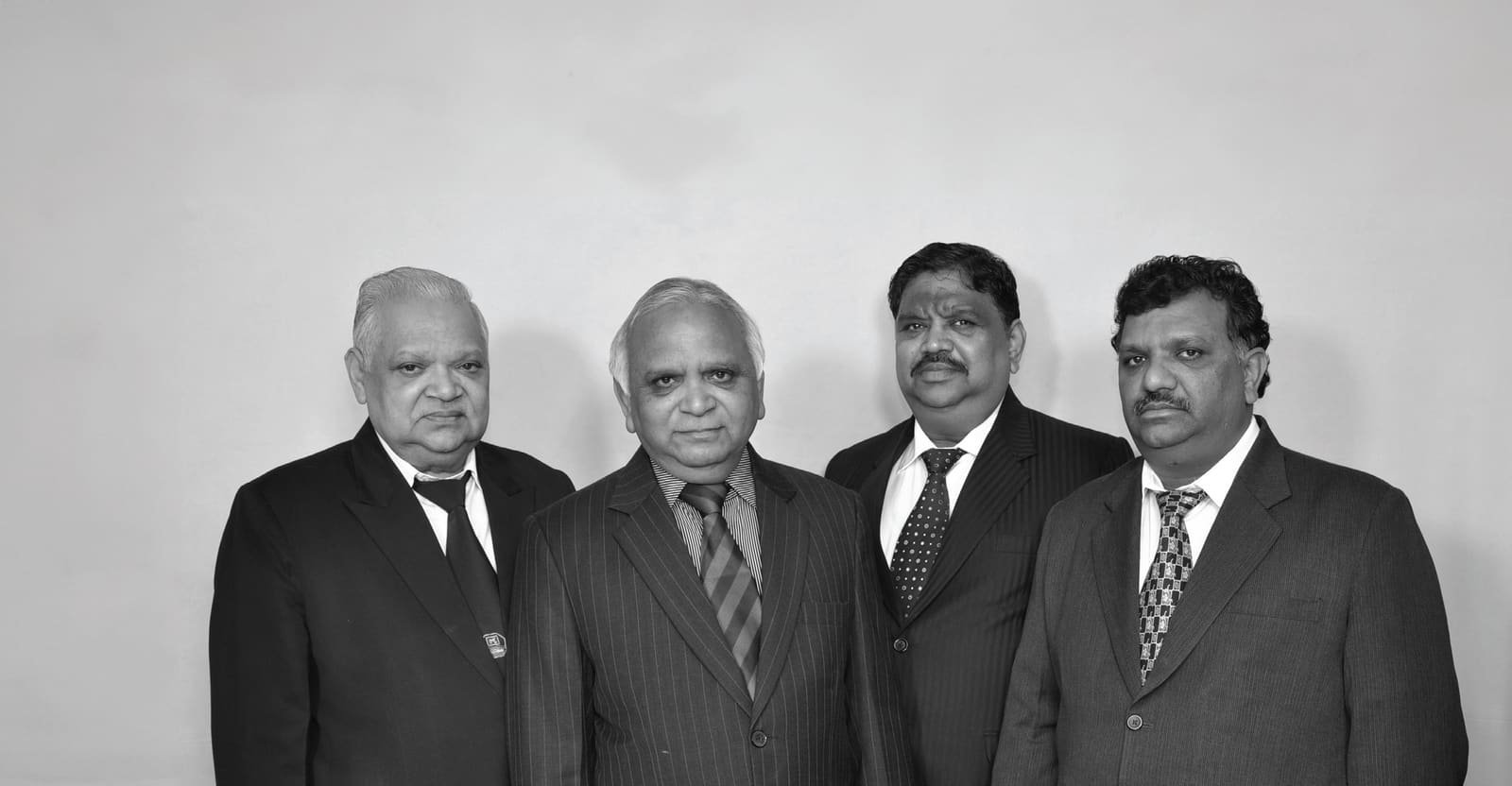 The founders of Ashtech Group photographed together in black and white