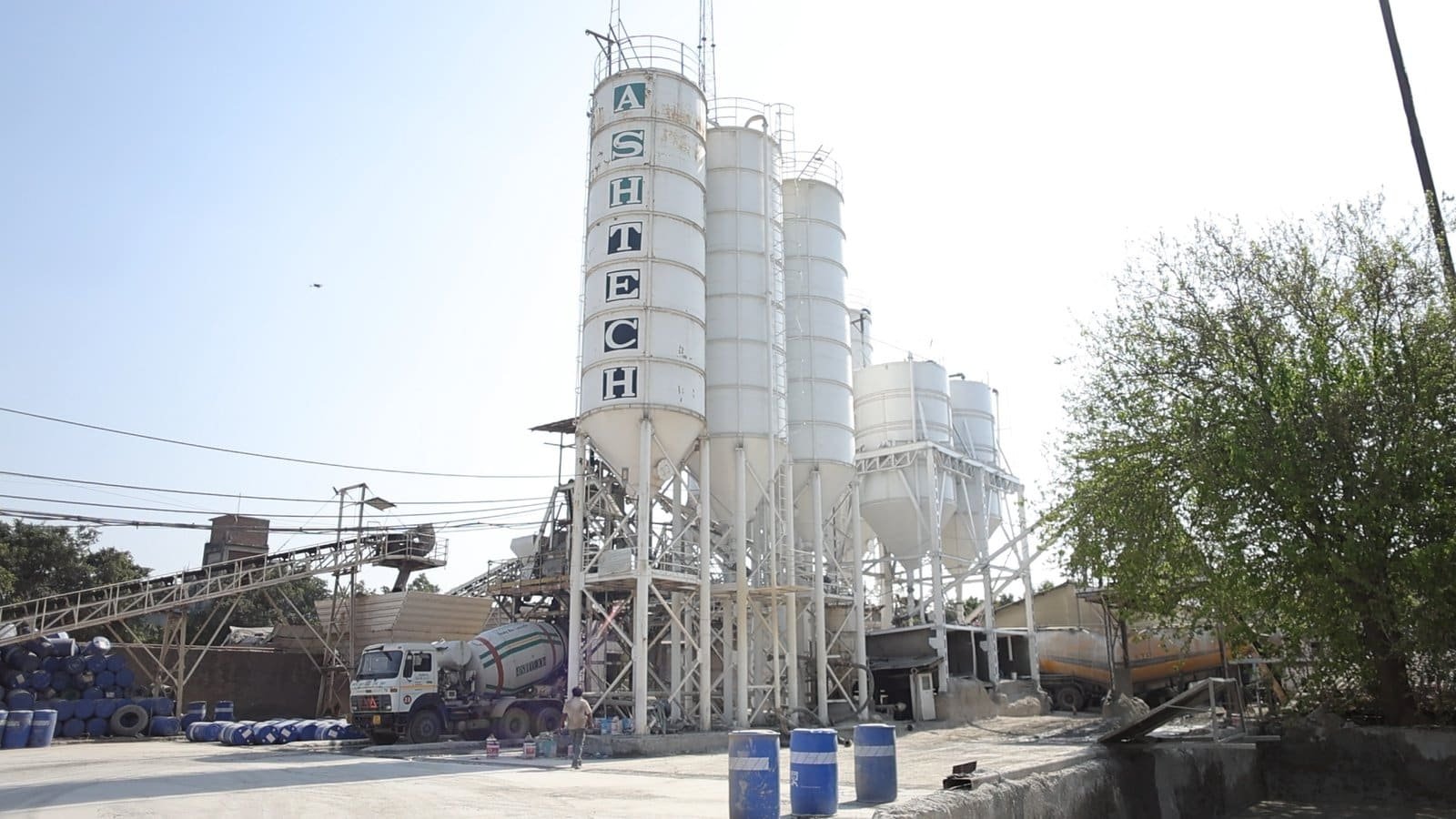 Ashtech Group ready-mix concrete plant with storage silos and transit mixers
