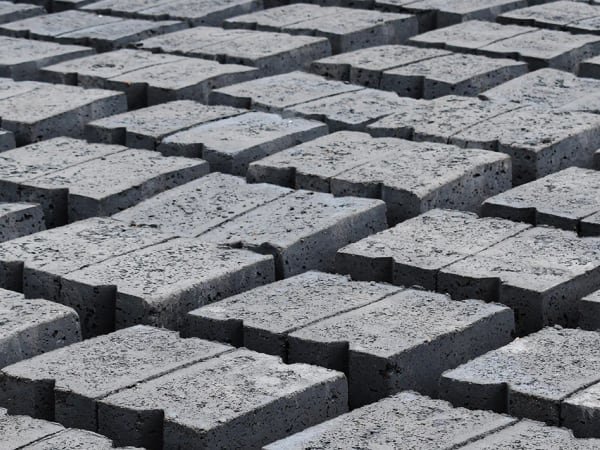 Fly ash bricks and AAC blocks stacked in rows at an Ashtech Group plant